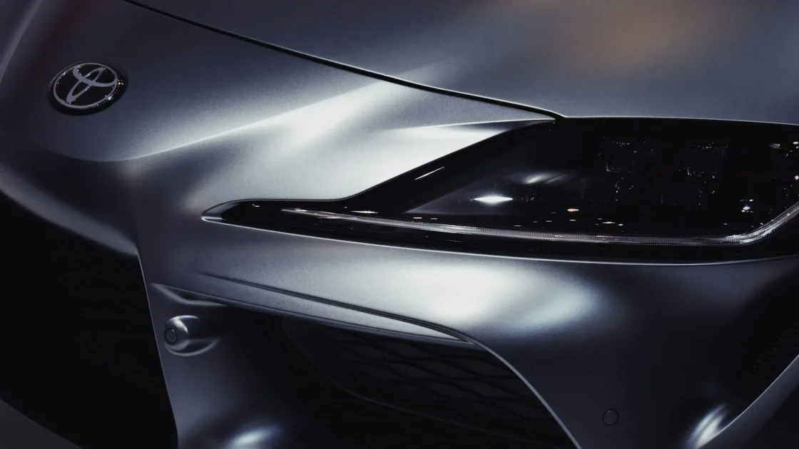 Front grille badge of a car concealing a radar sensor mounted directly behind the emblem for adaptive cruise control.