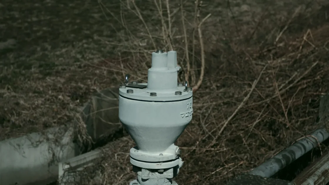 A weathered radar sensor connector showing early corrosion where moisture has crept into the wiring on an older vehicle.