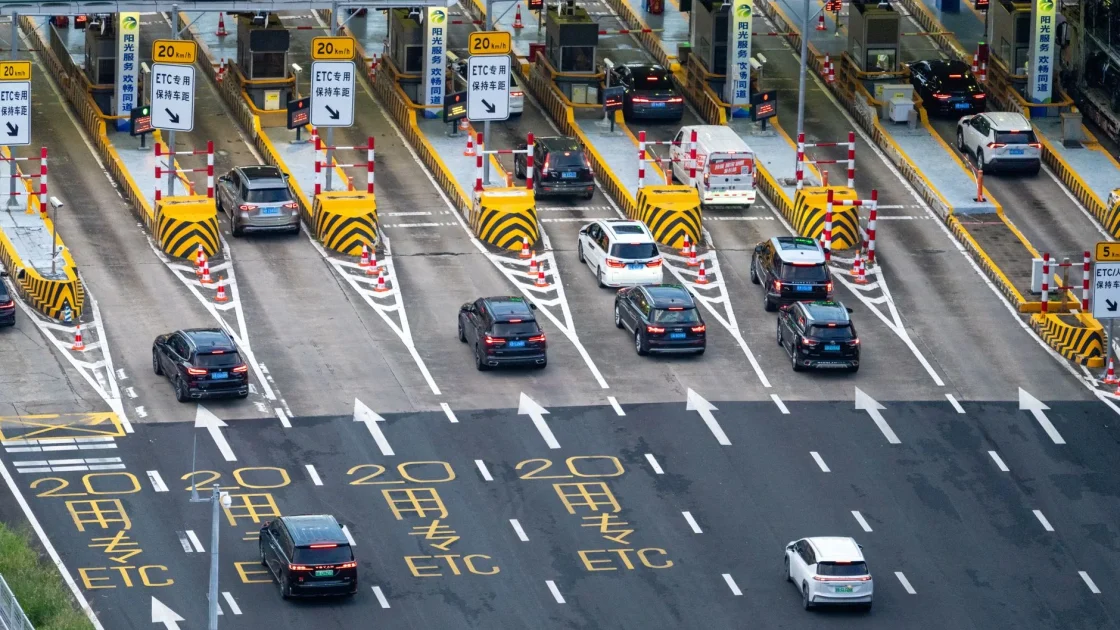 A car tracking clear white lane markings on a highway as the lane centering system follows the lines.