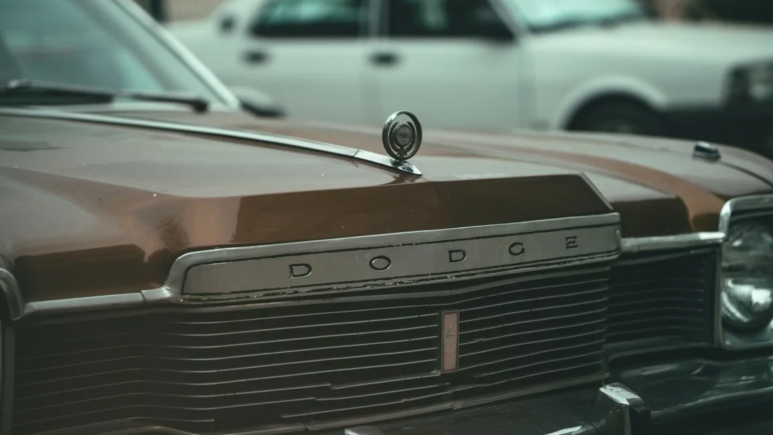Front grille of a car with the hidden radar sensor location highlighted behind the emblem.