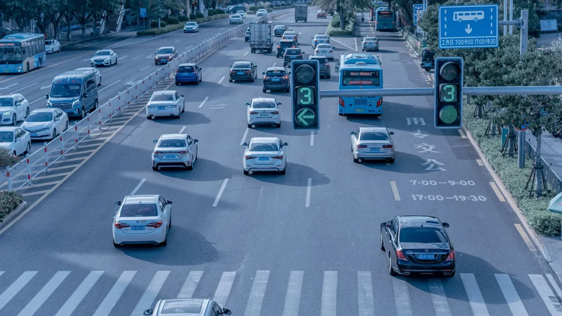 A conceptual view of a car using radar and laser sensors to scan the road and vehicles ahead.