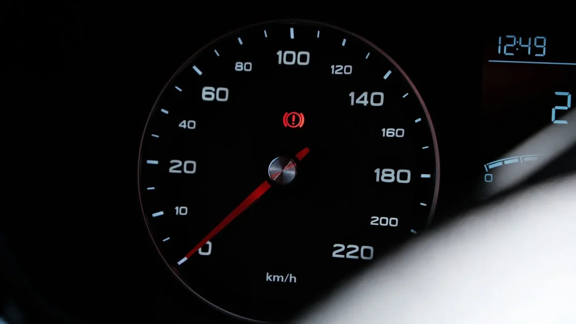 The front grille of a car with a forward radar sensor module used for automatic emergency braking visible behind the emblem.