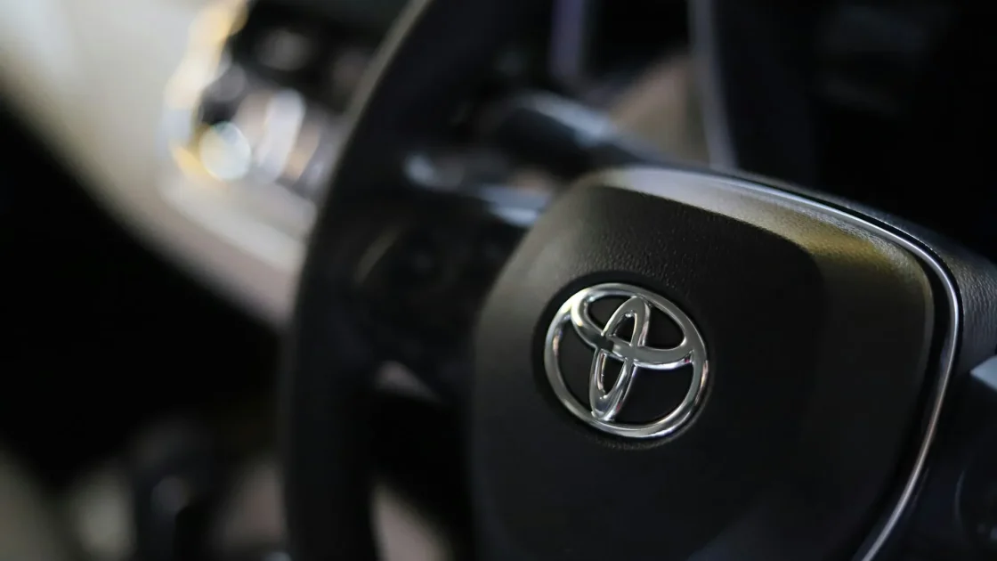 Toyota windshield with the forward camera housing visible behind the rearview mirror.