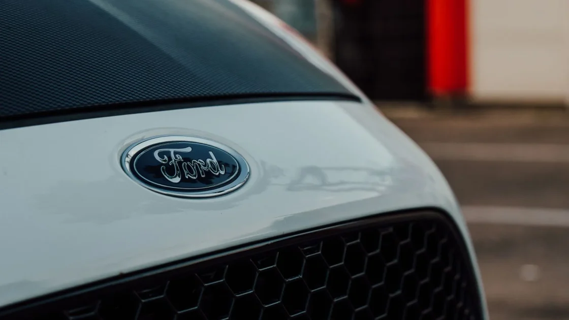 The front grille and lower bumper of a car where the hidden forward radar sensor sits behind the emblem.