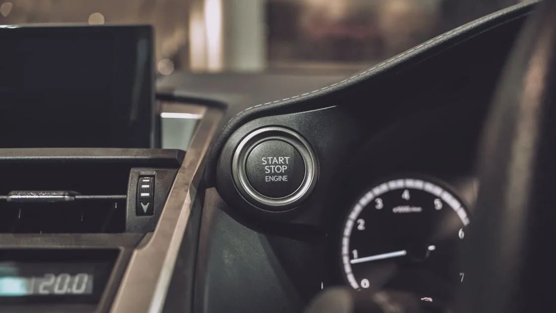 A driver pressing the steering wheel buttons that toggle adaptive cruise control and lane keeping during a test drive.