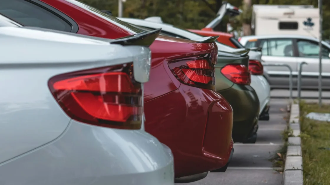 Close-up of round ultrasonic parking sensors set into a car's rear bumper.